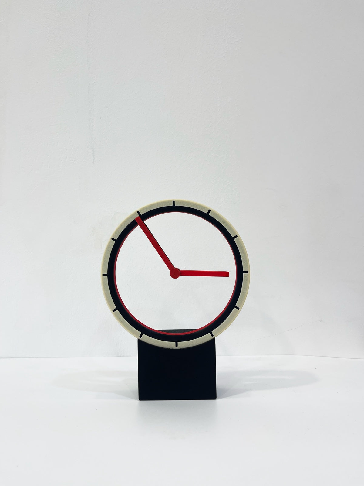 Kickback Clock — 45 degree side view showing walnut base and printed geometry